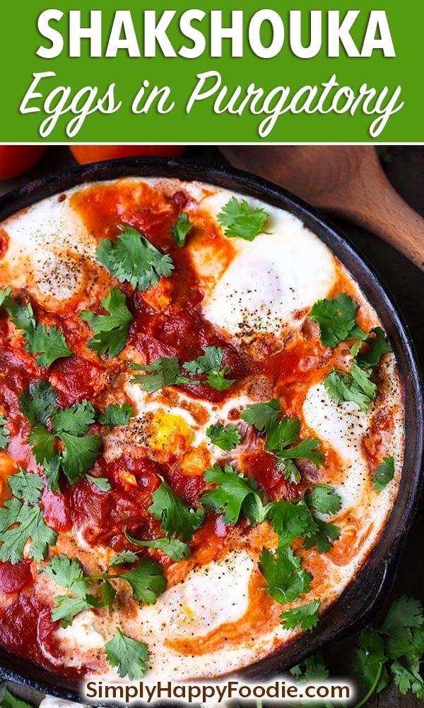 Shakshouka - Eggs in Purgatory is a Middle Eastern tomato and egg dish with delicious spices, onion, and feta cheese. Shakshuka is a great brunch recipe! simplyhappyfoodie.com #shakshouka #eggsinpurgatory #brunchrecipes #eggsintomatosauce eggs in tomato sauce