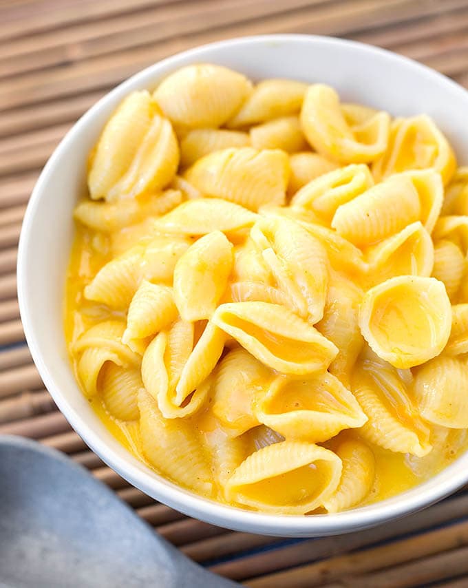 Instant Pot Mac and Cheese in a white bowl on bamboo mat