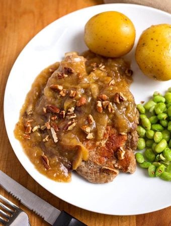 Instant Pot Autumn Apple Pork Chops are rich and warm tasting with just a hint of cinnamon and nutmeg. My family's absolute favorite pork chop recipe! simplyhappyfoodie.com #instantpotrecipes #instantpotporkchops #instapotporkchops #instapotrecipes