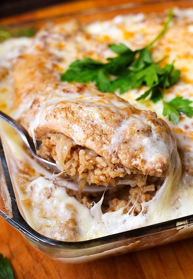 Silver spoon serving French Onion Chicken and Rice from glass casserole dish