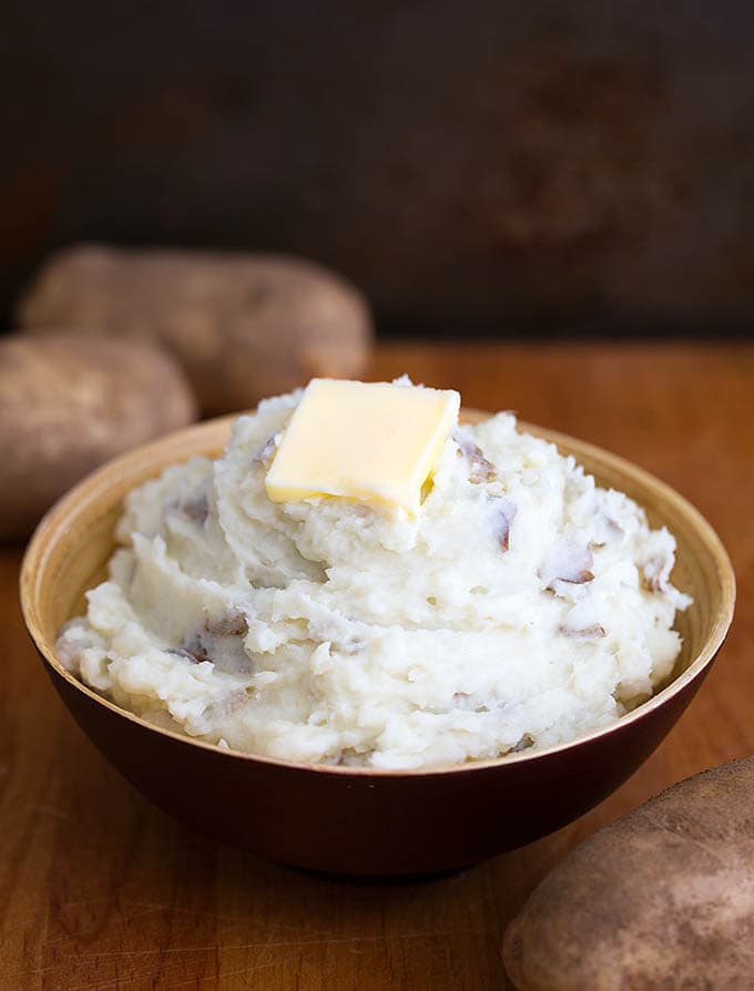 Mashed Potatoes with a slice of butter,in a brown bowl