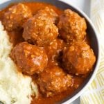 Porcupine Meatballs with mashed potatoes in a white bowl