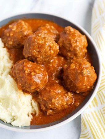 Porcupine Meatballs with mashed potatoes in a white bowl