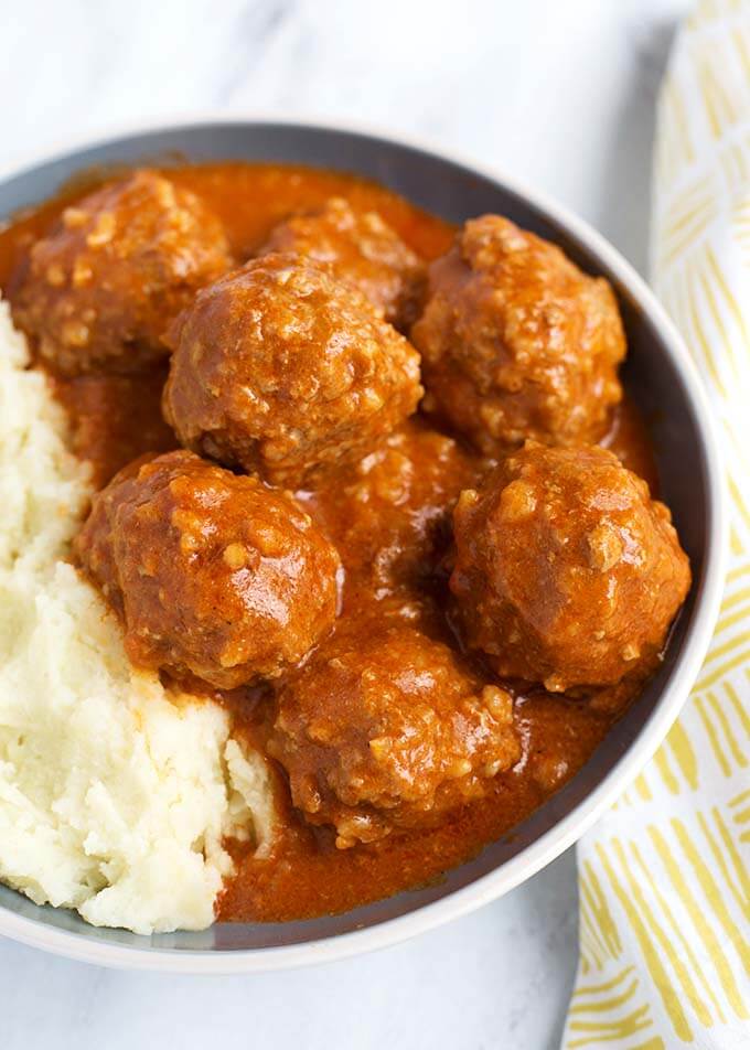 Porcupine Meatballs with mashed potatoes in a white bowl