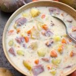 Instant Pot Potato Ham Soup in a beige bowl with veggies