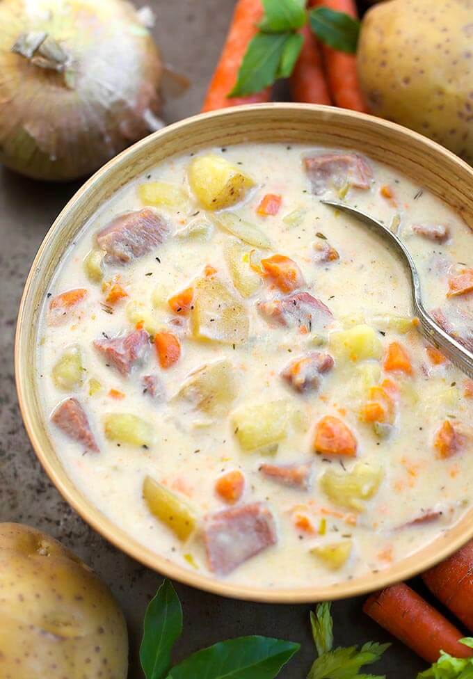 Instant Pot Potato Ham Soup in a beige bowl with veggies