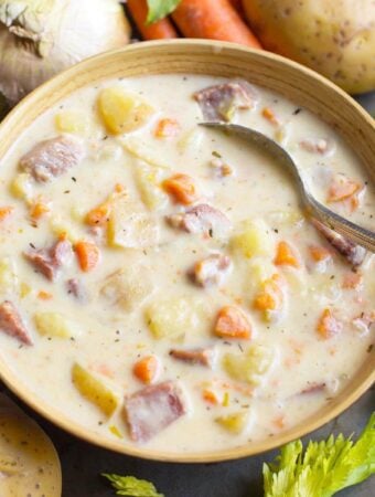 Instant Pot Potato Ham Soup in a beige bowl with veggies