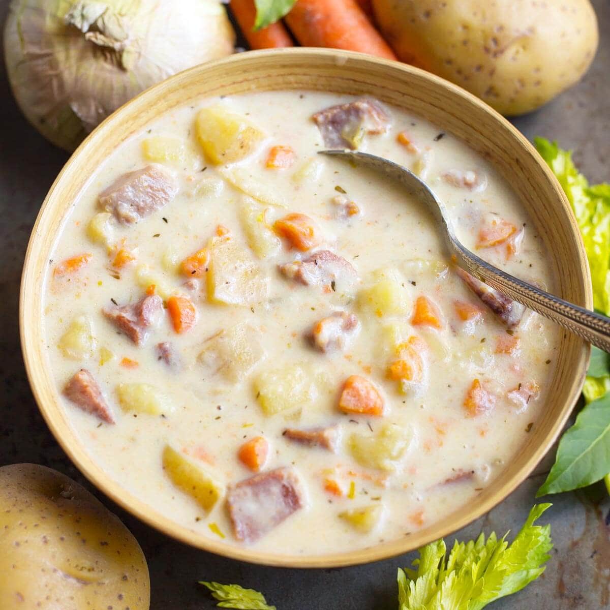 Instant Pot Potato Ham Soup in a beige bowl with veggies