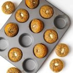 Orange Chocolate Cream Cheese Muffins in a muffin pan on a white background