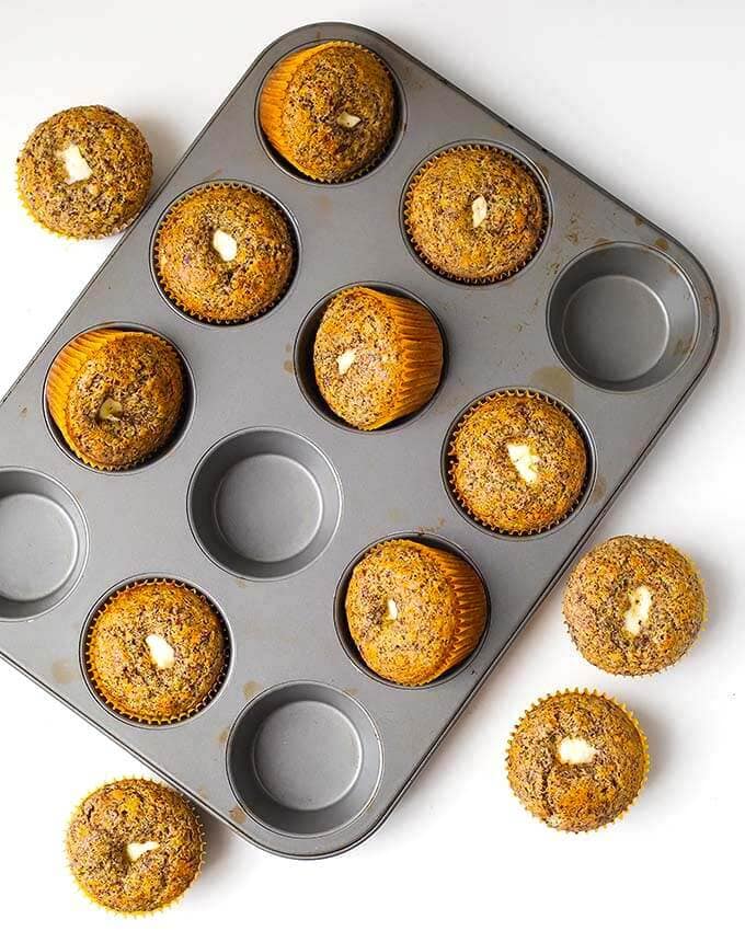 Orange Chocolate Cream Cheese Muffins in a muffin tin on a white background