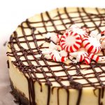 Instant Pot White Chocolate Peppermint Cheesecake garnished with peppermint candies on white background