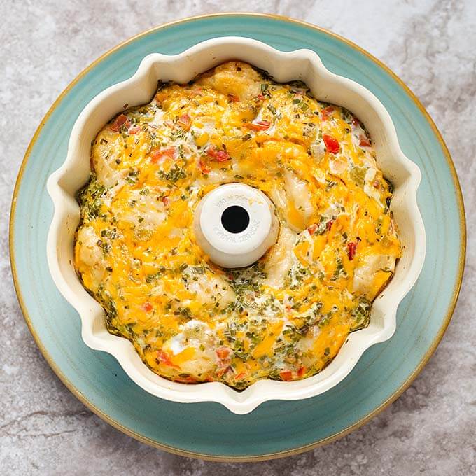 Instant pot southwest biscuit egg bake in a white bunt pan on top of a turquoise plate