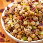 Instant Pot Stuffing in a white bowl on a wooden board