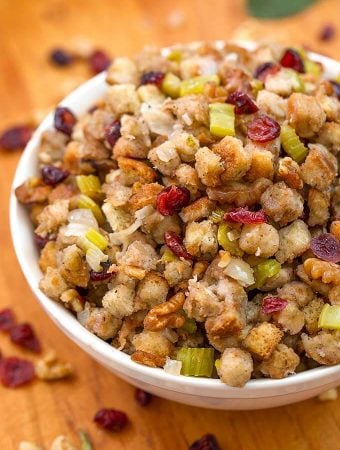 Instant Pot Stuffing in a white bowl on a wooden board