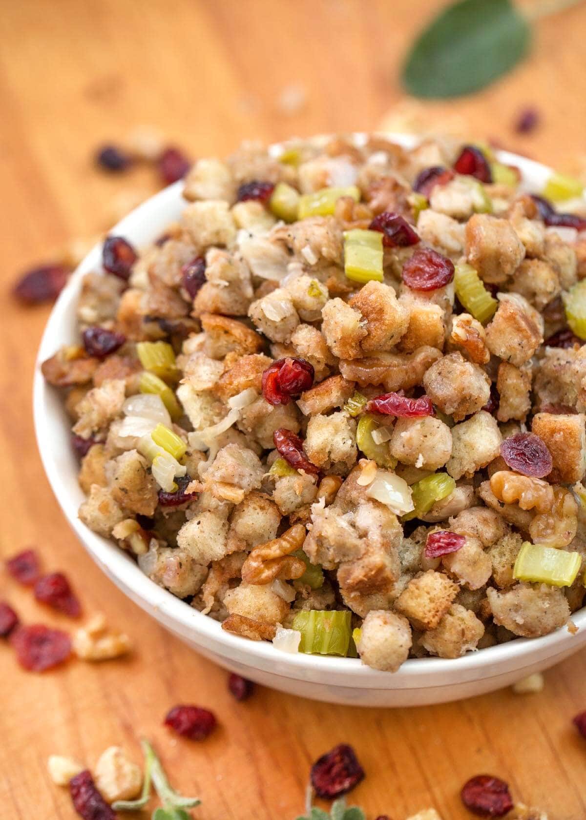 Instant Pot Stuffing in a white bowl on a wooden board