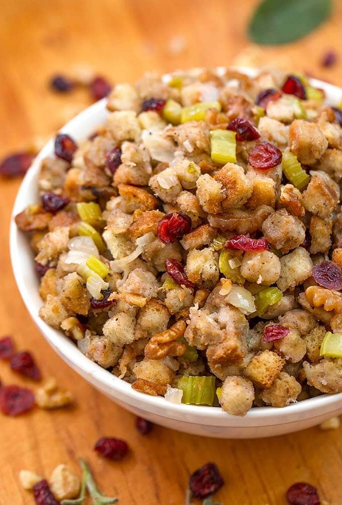 Instant Pot Stuffing in a white bowl on a wooden board