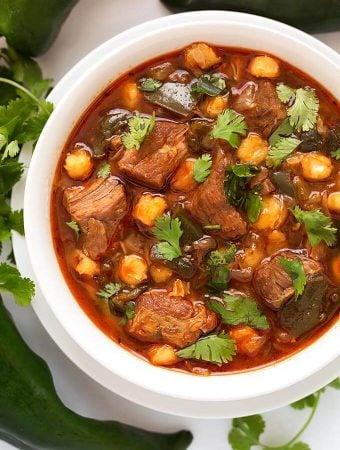 Instant Pot Posole - Pork Stew is Posole with a few extras. Poblano chile peppers and chipotle make this a spicy one pot meal. ¡Es muy deliciosa! simplyhappyfoodie.com #instantpotrecipes #instantpotposole #instantpotpozole #instantpotporkstew #pressurecookerrecipes