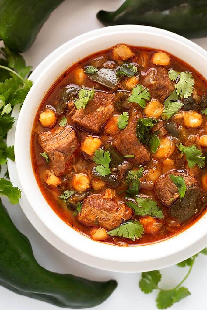 Instant Pot Posole - Pork Stew is Posole with a few extras. Poblano chile peppers and chipotle make this a spicy one pot meal. ¡Es muy deliciosa! simplyhappyfoodie.com #instantpotrecipes #instantpotposole #instantpotpozole #instantpotporkstew #pressurecookerrecipes