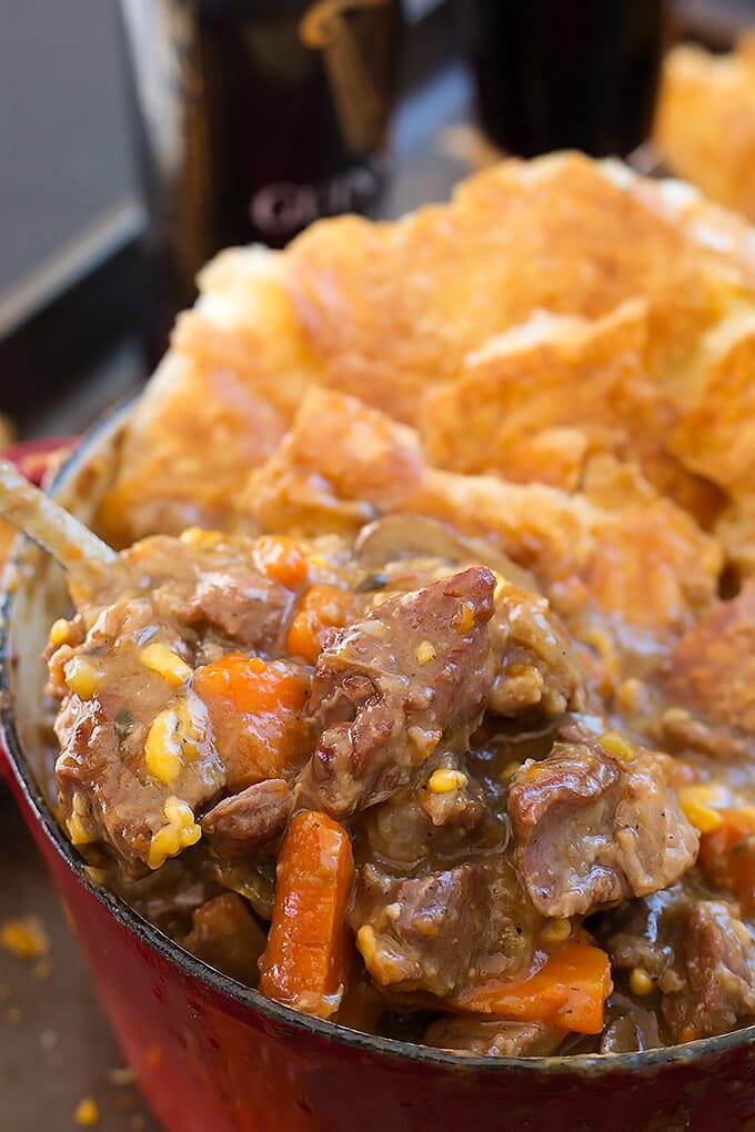 Instant Pot Beef Guinness Stew in a bowl and on a spoon.