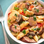 Instant Pot Creamy Cajun Pasta with Sausage is a super delicious one pot meal with penne pasta, smoky kielbasa, red bell pepper, mushrooms, and a creamy sauce. Pressure cooker one pot meal! simplyhappyfoodie.com #instantpotrecipes #instantpotpasta #instantpotcajunpasta #pressurecookerpasta