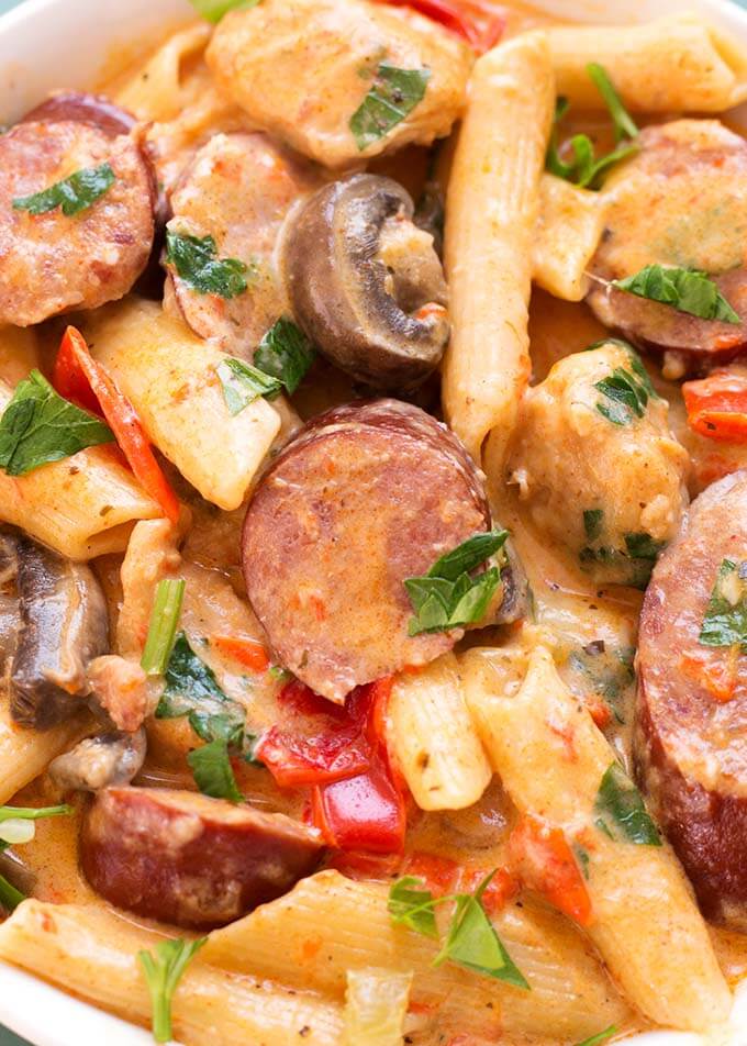 Close up of Creamy Cajun Pasta with Sausage in white bowl