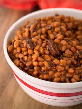 Smoky Sweet Baked Beans in a white bowl on wooden board
