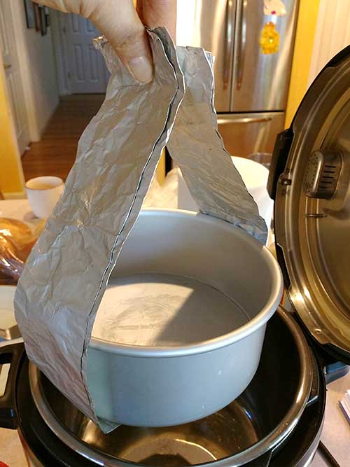 Aluminum foil sling lifting round pot out of pressure cooker