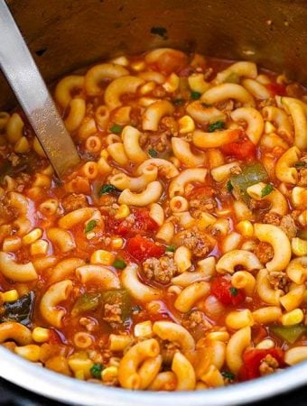 American Goulash in pressure cooker pot with serving ladle