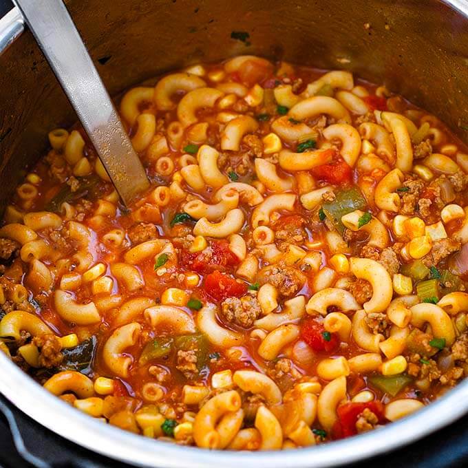 American Goulash in pressure cooker pot with serving ladle 