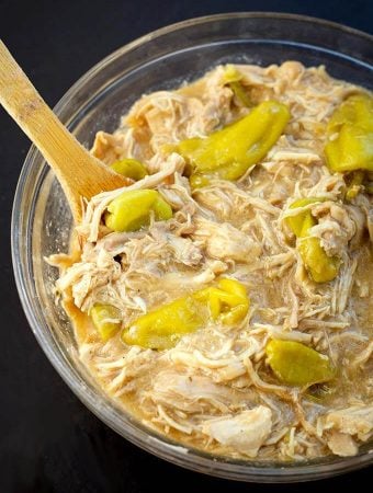 Mississippi Chicken in a glass bowl with wooden spoon