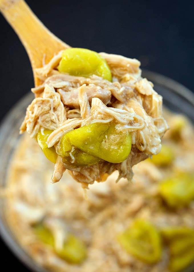 Close up of spoonful of Mississippi Chicken on wooden spoon