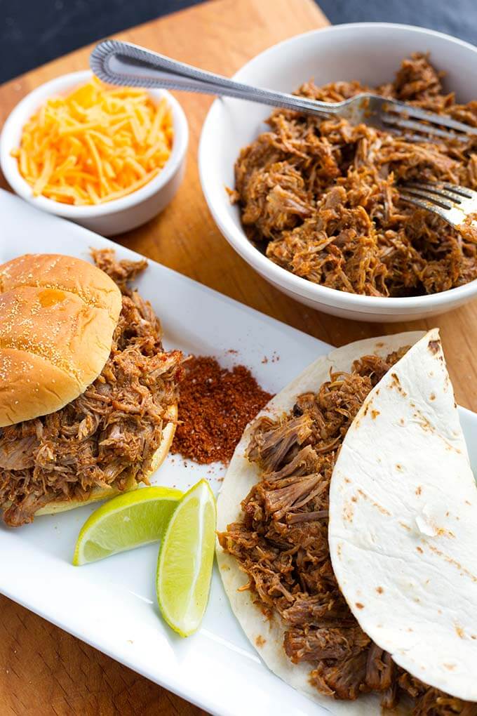 Instant Pot Pulled Pork in tortilla, on bun, in white bowl