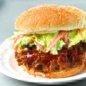 Instant Pot Pulled Pork sandwich with coleslaw on white plate