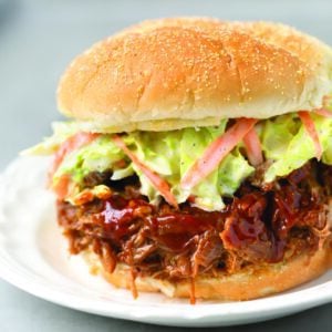 Instant Pot Pulled Pork sandwich with coleslaw on white plate
