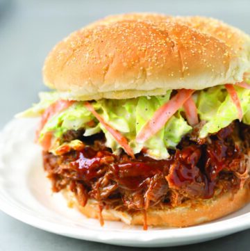 Instant Pot Pulled Pork sandwich with coleslaw on white plate