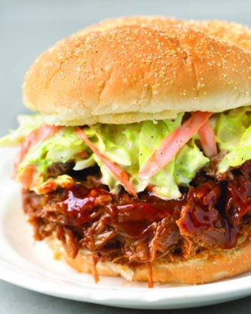 Instant Pot Pulled Pork sandwich with coleslaw on white plate