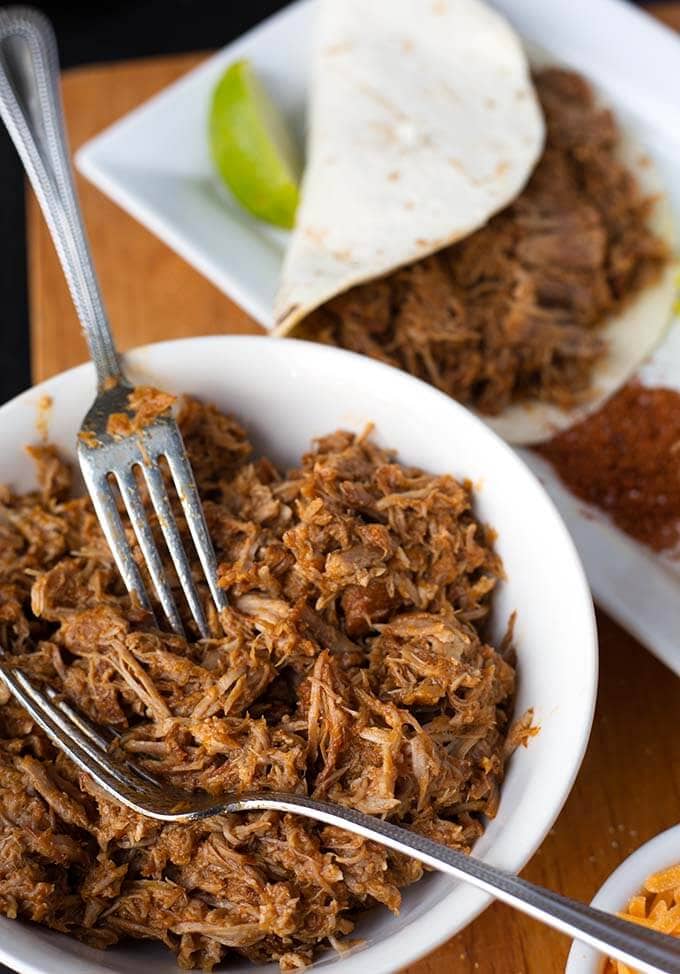 Instant Pot Pulled Pork in white bowl with forks