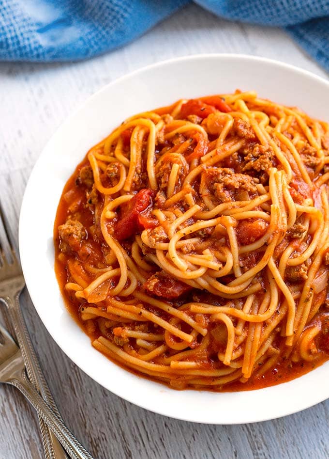 instant pot Spaghetti in white bowl next to two forks