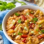 Unstuffed Cabbage Rolls in white bowl and spoon on blue kitchen towel