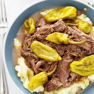 Mississippi Pot Roast in blue bowl next to fork