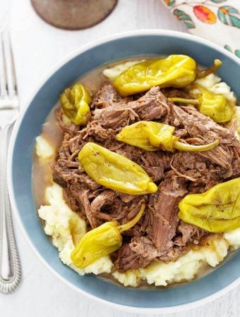 Mississippi Pot Roast in blue bowl next to fork