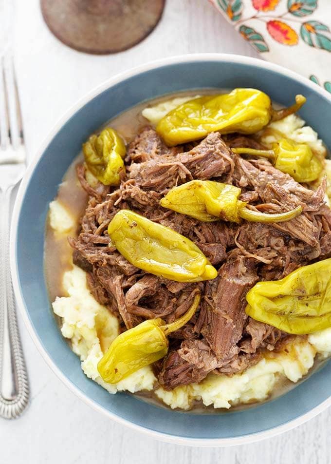 Mississippi Pot Roast in blue bowl next to fork