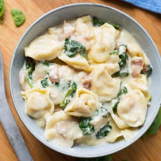Instant Pot Tortellini Alfredo with chicken and spinach is so amazingly flavorful and rich. This is a tasty Instant Pot one-pot pasta meal. Make this pressure cooker Tortellini Alfredo when you want the best comfort food! simplyhappyfoodie.com #instantpotrecipes #instantpottortellinialfredo #instantpotchickenalfredo #pressurecookertortellinialfredo