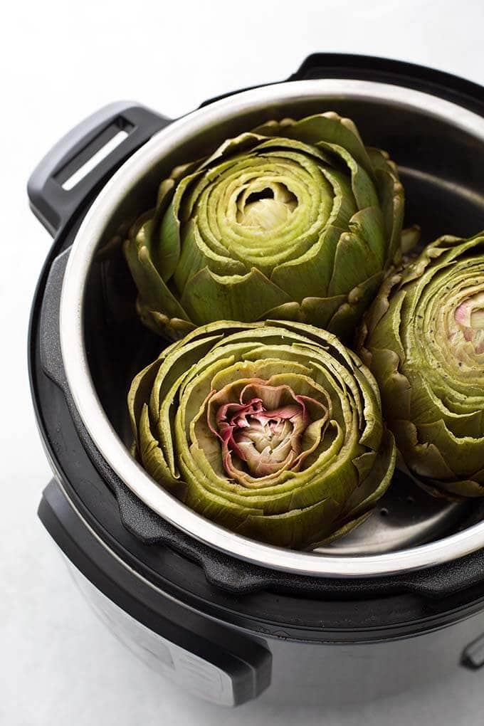 Three Whole Steamed Artichokes in a pressure cooker