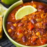 Instant Pot Chili in a green bowl topped with a slice of lime