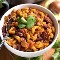 Instant Pot Chili Mac in a white bowl with spoon