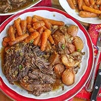Balsamic Pot Roast with carrots and potatoes on a white and red plate
