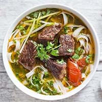 Vietnamese Beef Stew Pho Noodle Soup in a white bowl