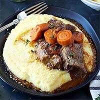 Instant Pot Short Ribs with Creamy Polenta on a blue plate