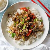 Instant Pot Mongolian Beef over rice on a white plate